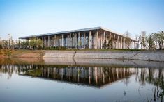 a large building sitting on the side of a lake