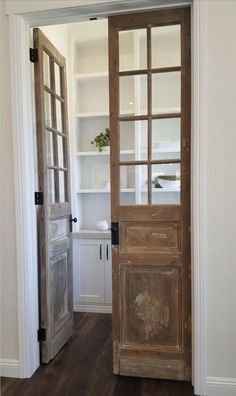 an open wooden door in a white room