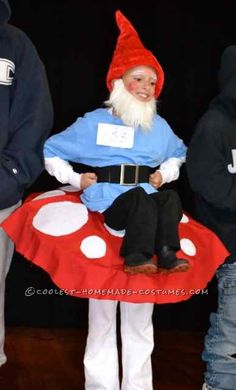 a gnome sitting on top of a red mushroom