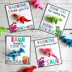 four dinosaur valentine's cards on a table