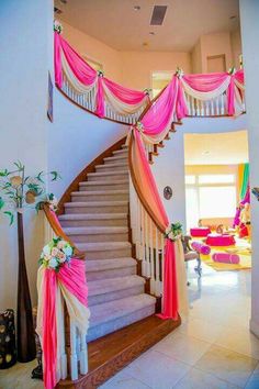 the stairs are decorated with pink and white draping for an elegant wedding ceremony