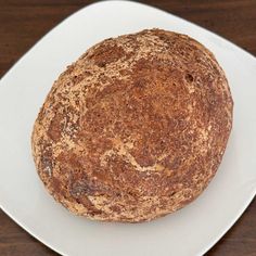 a round bread sitting on top of a white plate