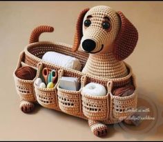 a crocheted dog is sitting in a basket