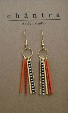 the earrings are made with gold, black and white beads on them's hooks