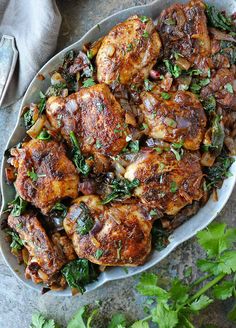 chicken with herbs and parsley in a serving dish