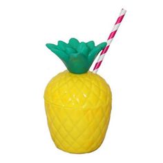 a plastic pineapple drink holder with two striped straws in it's mouth