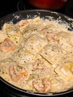 shrimp and dumplings are being cooked in a skillet