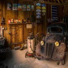 an old car is parked in a garage next to a gas pump and other items