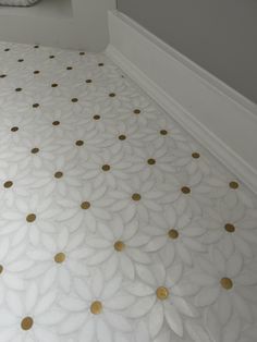 a white bed with gold polka dots on it