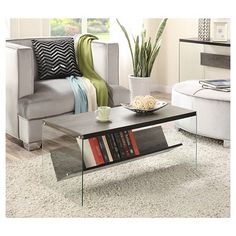 a coffee table with books on it in a living room