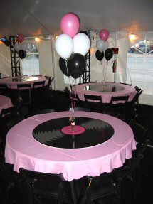 a party with black, white and pink balloons in the shape of vinyl record records