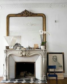 a living room with a fireplace and mirror