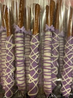 there are many purple and white desserts wrapped in plastic