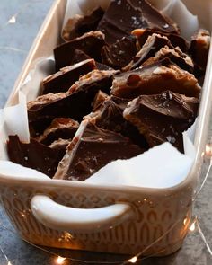 chocolate pieces in a white dish on a table