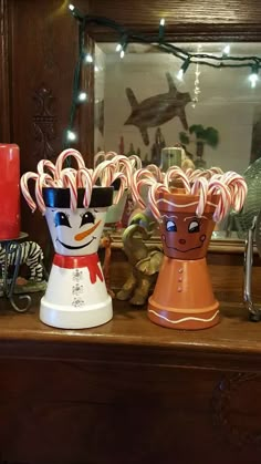 some candy canes are sitting on top of a shelf in front of a mirror