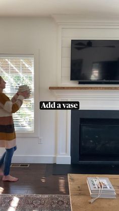 a woman standing in front of a tv with the words add a vase on it