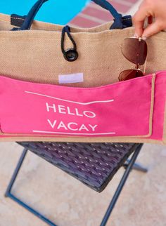 This item is in stock and ready to be shipped. Furthermore, it can also be picked up locally in Magnolia, TX. If you spend more than $99, the shipping costs will be covered by me! Display your vacation spirit with the Hello Vacay Beach Bag! This fun bag features a pop of pink and the words 'hello vacay' on the front. The roomy interior and extra front pocket with velcro make it perfect for stashing your beach essentials. Keep it all together with the button closure and handles. (Time to start pl Trendy Pouch Beach Bag For Vacation, Beach Season Travel Pouch Shoulder Bag, Summer Travel Pouch Bag, Large Capacity Beach Bag For Travel, Large Capacity Canvas Bag For Vacation, Trendy Travel Shoulder Bag For Vacation, Trendy Shoulder Bag For Travel And Vacation, Summer Beach Bag Pouch For Vacation, Trendy Pouch Beach Bag For Travel