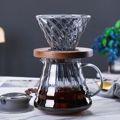 a glass coffee pot sitting on top of a table