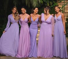 the bridesmaids are all dressed in lavender colored gowns and posing for a photo