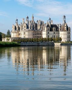 a large castle sitting on top of a lake