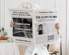 a woman sitting in a chair holding up a newspaper with the front page of a news paper