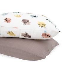 two pillows sitting next to each other on top of a pillow case with animals printed on them