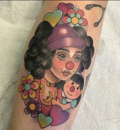 a woman with a clown nose holding a child on her arm, in the shape of a heart