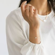 This sleek gold chain bracelet with a graceful oval-shaped mother of pearl centerpiece complements all styles. This sweet bracelet is perfect for mixing in a stack or wearing solo for a minimal look. Made with recycled metals, for the earth friendly at heart. Available in 6.5" or 7.5" lengths Both lengths include a 1" long extender chain Mother of Pearl is 4mm x 6mm Recycled 14k gold over sterling silver Pearl Centerpiece, Gold Chain Bracelet, Minimal Look, Gold Bracelet Chain, Recycled Gold, Earth Friendly, Pearl Bracelet, The Earth, Chain Bracelet