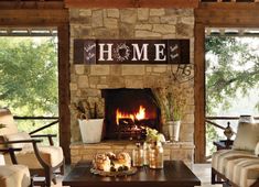 a living room filled with furniture and a fire place in front of a stone fireplace