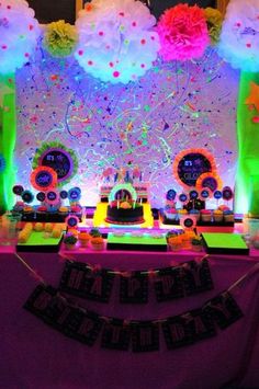 an image of a birthday party setting with cake and decorations on the table in front of it