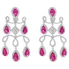 Stunning chandelier earrings featuring an intricate design crafted from 18-karat white gold. They are adorned with dazzling white diamonds that beautifully contrast with the vibrant rose-hued rubelites. Designed in a classic chandelier style, the earrings showcase multiple teardrop-shaped rubelites cascading elegantly, making them a luxurious addition to any special occasion. Diamond Total Weight: 7.28 carats Rubelite Total Weight: 20.29 carats All Mozafarian jewellery comes with a valuation certificate. Stunning Chandelier, Diamond Chandelier Earrings, Diamond Chandelier, White Gold Hoop Earrings, Thick Hoop Earrings, Classic Chandelier, Gold Chandelier Earrings, White Gold Hoops, 18k Gold Earrings