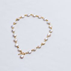 Celebrate your love for all things vintage with this handmade baroque pearl matching set. Each shimmering white cultured pearl features a unique shape, making these pearls a true treasure from the sea to cherish. Shiny, rich yellow gold plated spacer beads interplay with the pearls, creating a fusion of classic meets trendy style. Elongated hook clasps close the necklace, adding a luxurious touch. Created with an antique inspiration, purchase this set together or separately and showcase their el Gold Pearl Toggle Necklace With Pearl Drop, Gold Pearl Drop Toggle Necklace, Gold Toggle Necklace With Pearl Drop, Gold Pearl Toggle Necklace With Pearl Chain, Gold Toggle Necklace With Pearl Chain, Gold Pearl Toggle Necklace, Coin Pearl Necklace, Toggle Necklace, Pearl Jewelry Necklace