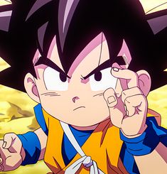 the young gohan is holding his hand up to his ear and pointing at something