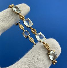 * Gorgeous 18k Yellow Gold Oval Aquamarine March Anniversary 7" Tennis Bracelet * Metal: 18k Yellow Gold * Stone(s): (8) Oval Cut Aquamarine Aquamarines measure approximately 10.0 x 8.0 mm each* Length: 7" * Width: 3/8" * Weight: 16.1 tgw * Markings: 18k * Condition: As pictured. * G2604 5% Restocking Fee    Exported By ExportYourStore :) Luxury Oval Gemstone Bracelet, Luxury Hand Set Oval Bracelets, Luxury Oval Tennis Bracelet As Gift, Luxury Oval Yellow Gold Bracelet, Luxury Oval Link Bracelet For Anniversary, Luxury 14k Gold Oval Bracelet, Formal Oval Yellow Gold Bracelet, Luxury Oval Bracelets For Formal Occasions, Luxury Yellow Gold Tennis Bracelet With Oval Links