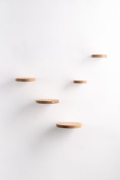 three wooden shelves on the wall with white background