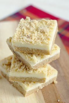 three pieces of cake sitting on top of a wooden cutting board