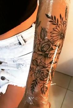 a woman's arm with flowers on it