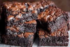 chocolate brownies are stacked on top of each other with one bite taken out of it