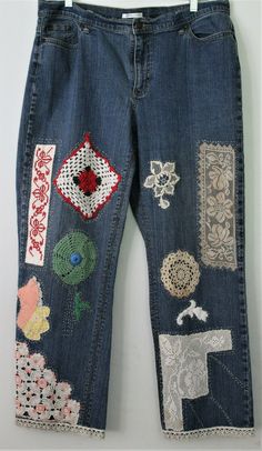 an old pair of jeans with embroidered patches on them