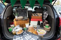 a trunk full of food and snacks in the back of a car