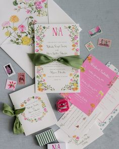 the wedding stationery is laid out on top of each other with matching envelopes