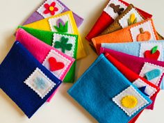 several colorful felt squares with embroidered designs on them