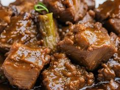 some meat and sauce on a plate with a green pepper in the middle, ready to be eaten