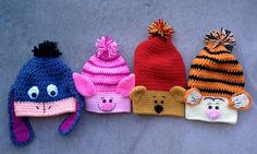 five knitted animal hats lined up next to each other