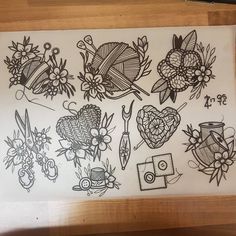 a drawing of flowers and knitting needles on a piece of white paper with black ink