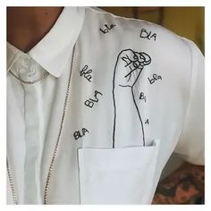 a man wearing a white shirt with a drawing on it