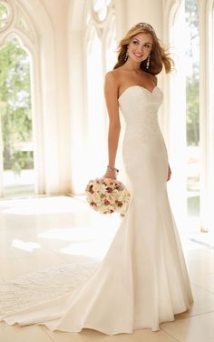 a woman in a wedding dress holding a bouquet