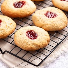 cookies with jam are cooling on a wire rack