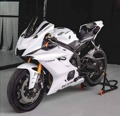 a white and black motorcycle parked in a garage