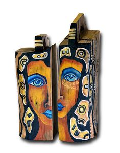 two pieces of art made out of wood and painted with different colors, shapes and sizes